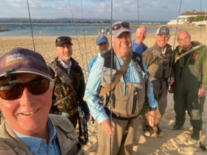 Bass Breakfast happy crowd of flyfishers on the beach at Sandbanks in Dorset