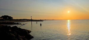 Flyfishers in sea with sunrise